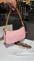 Signature monogram pink shoulder bag with charms