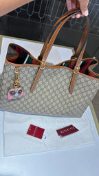 Signature monogram leather tote bag with charm