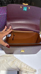 Quilted croc patterned sling bag