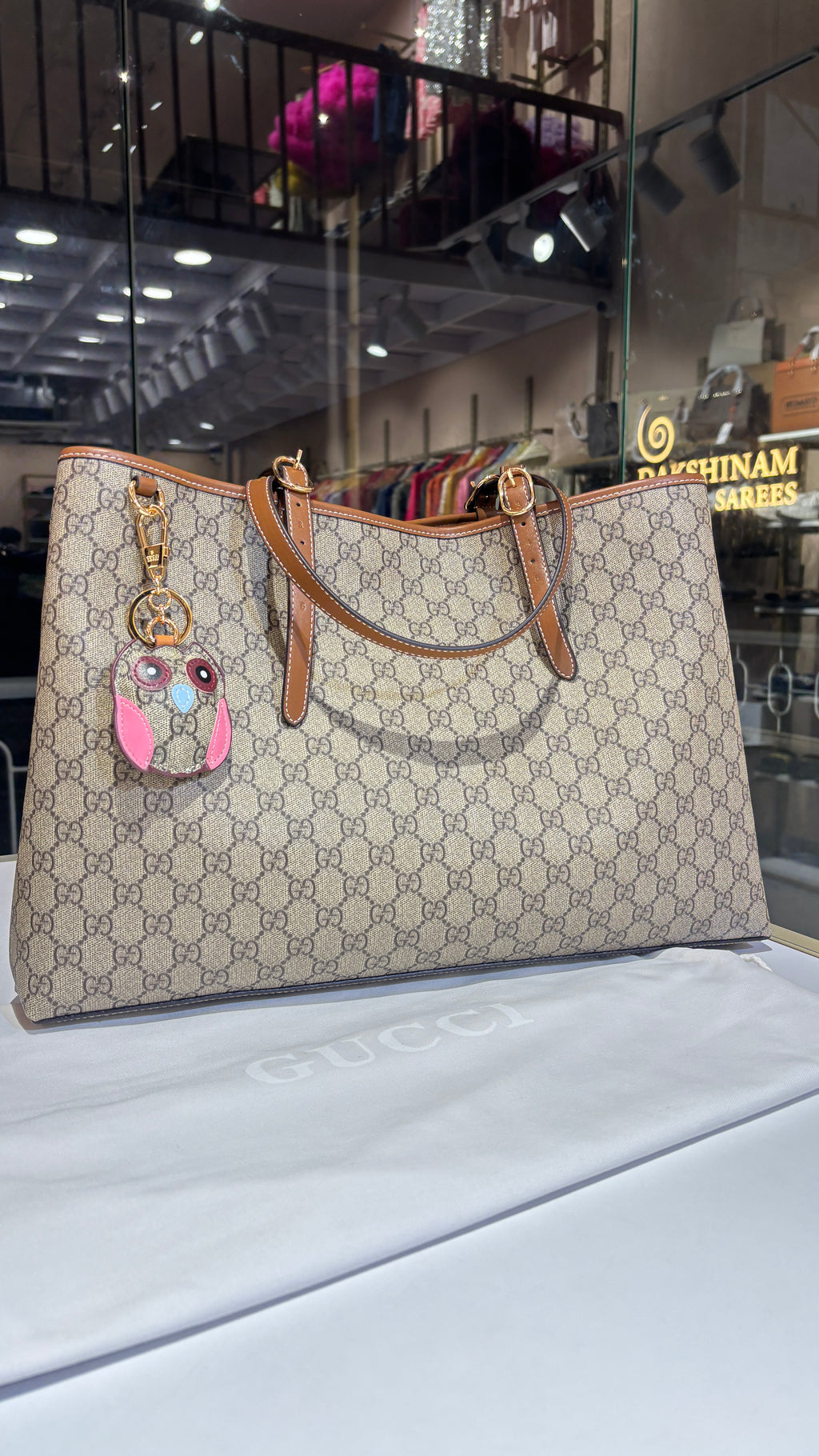 Signature monogram leather tote bag with charm