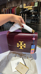 Quilted croc patterned sling bag