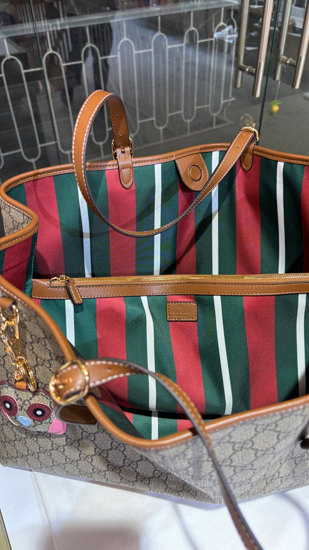 Signature monogram leather tote bag with charm