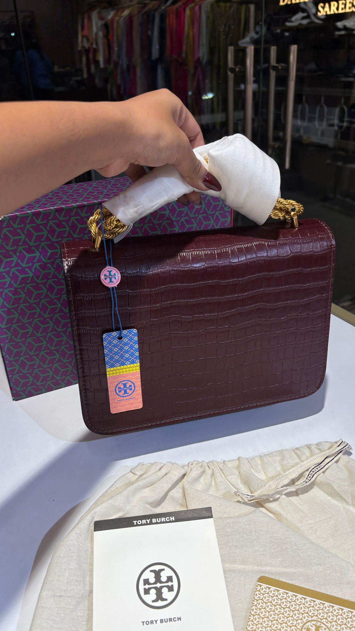 Quilted croc patterned sling bag