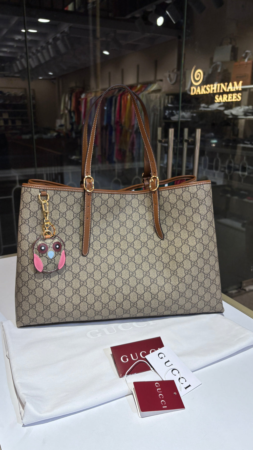 Signature monogram leather tote bag with charm