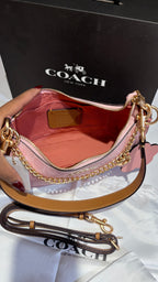 Signature monogram pink shoulder bag with charms