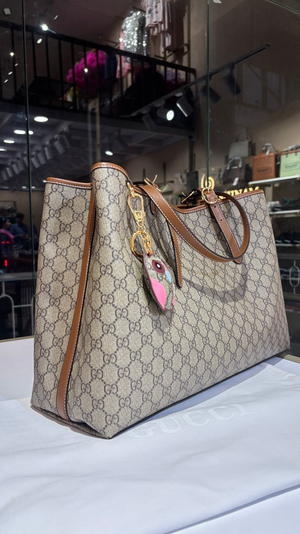 Signature monogram leather tote bag with charm