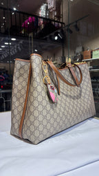 Signature monogram leather tote bag with charm