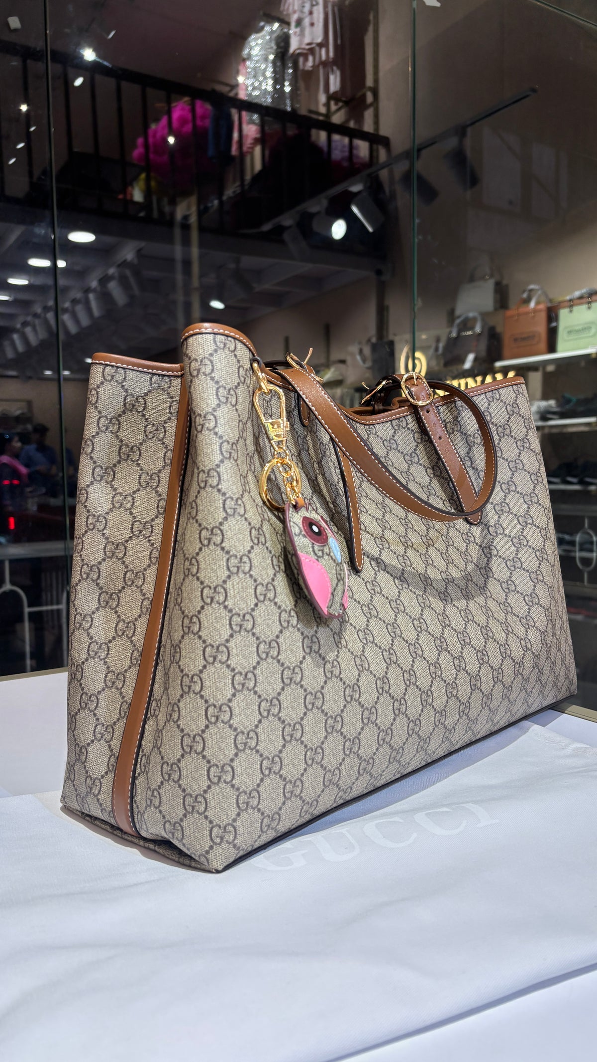 Signature monogram leather tote bag with charm