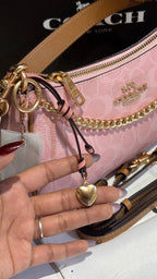 Signature monogram pink shoulder bag with charms