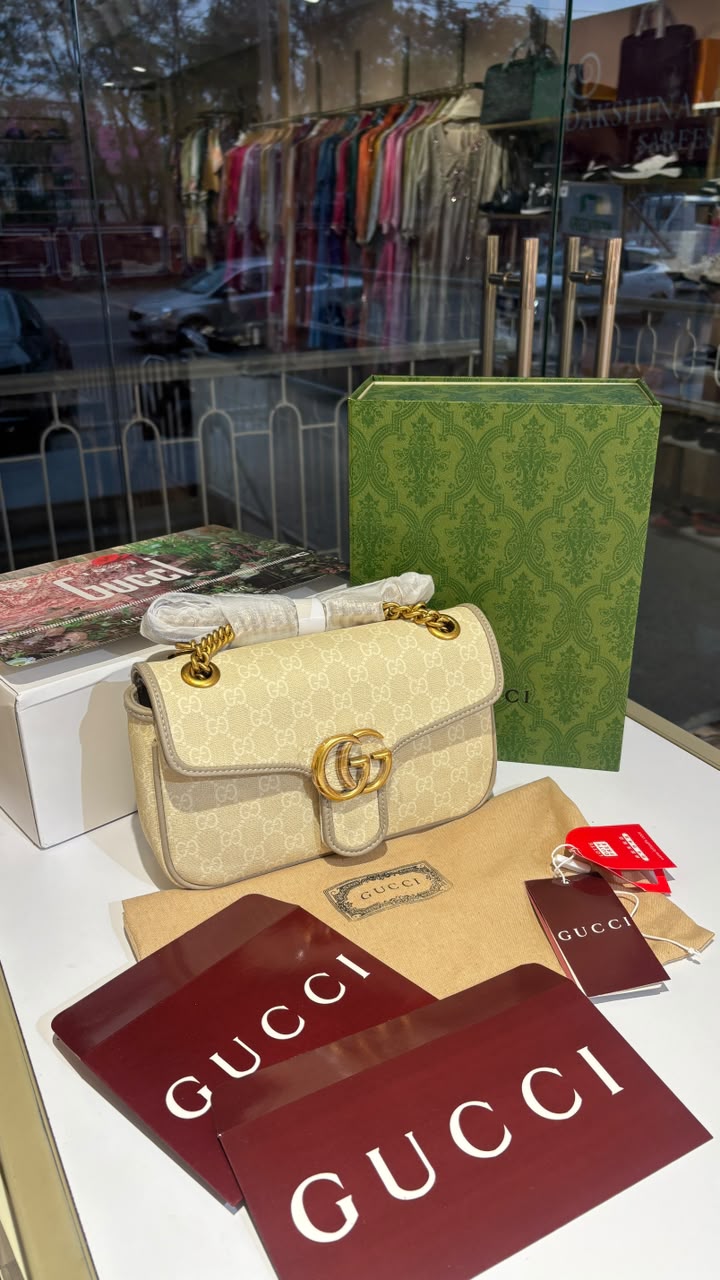 Structured monogram sling bag