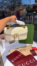 Structured monogram sling bag