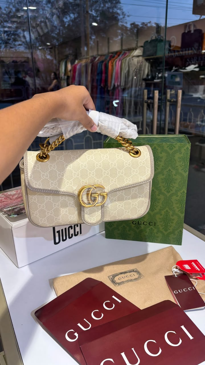 Structured monogram sling bag