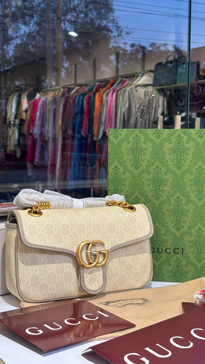 Structured monogram sling bag