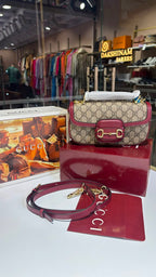 Structured monogram sling bag with detachable sling