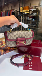 Structured monogram sling bag with detachable sling