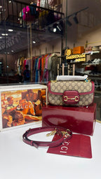 Structured monogram sling bag with detachable sling