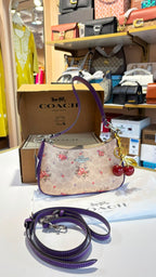 Floral print shoulder bag with cherry charm