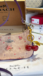 Floral print shoulder bag with cherry charm