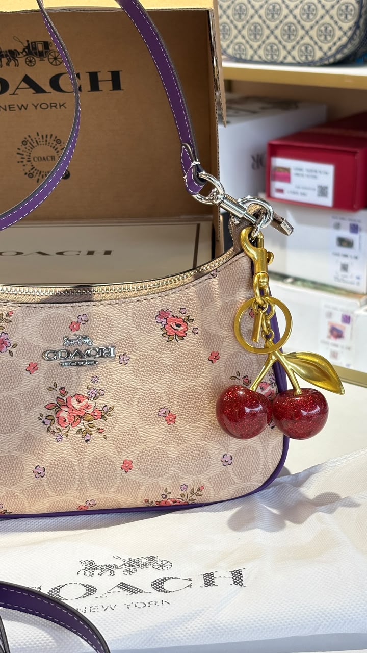 Floral print shoulder bag with cherry charm