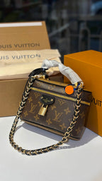 Signature monogram vanity bag with detachable slings