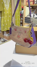Floral print shoulder bag with cherry charm