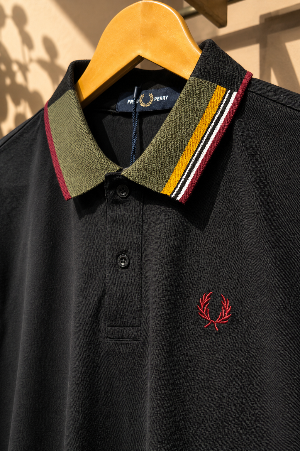 Black Polo T-Shirt with Multicolor Striped Collar.